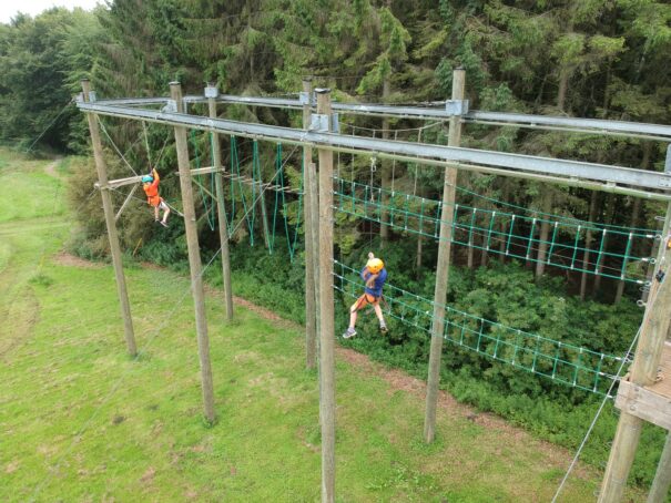 2 pupils taking on the Sky Ropes course